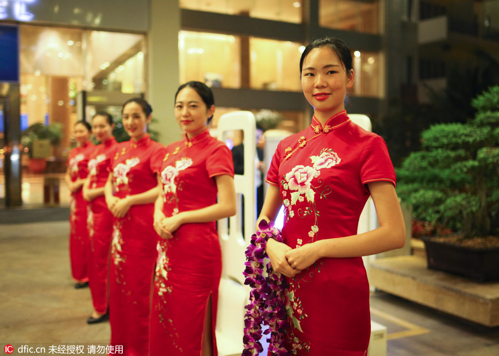 迎賓禮儀貌美如花，一襲中國紅旗袍將東方女性的身材優勢勾勒無遺，夜色下美女們整齊劃一靜候賓朋。 崔浩/東方IC
