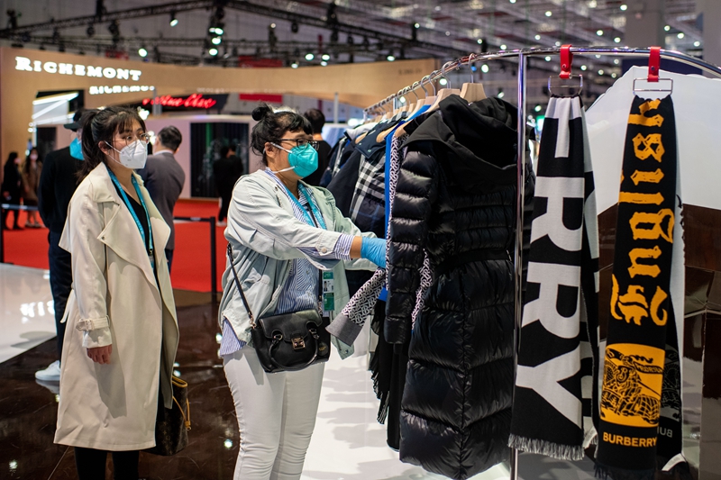 在第五屆進博會消費品展區，參觀者正在挑選burberry的新款服飾。人民網記者 翁奇羽攝