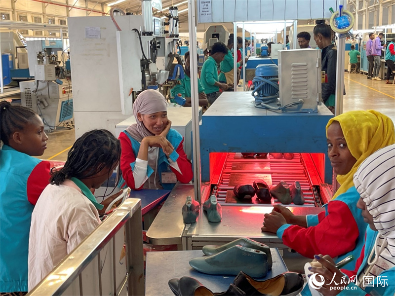 在华坚轻工业城，制鞋工人在生产线上工作。人民网记者 赵艳红摄