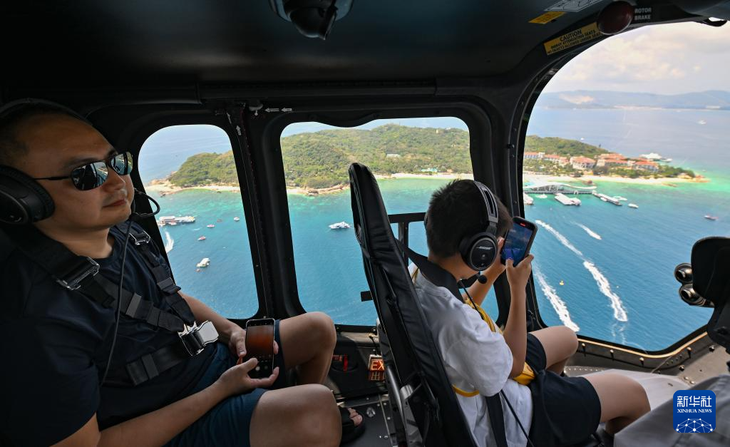 5月3日，游客在三亚海棠湾直升机观光基地（林阳通航）体验直升机飞行。新华社记者 郭程 摄