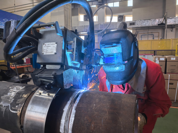 “管水平固定360度全自動氣保焊工藝開發”項目作業人員進行試驗件封底焊接。李景強攝